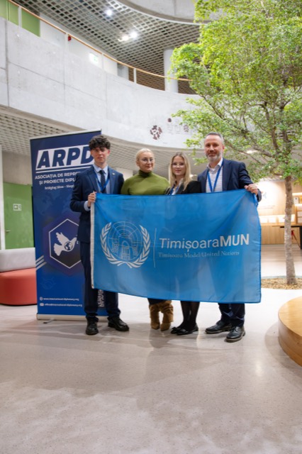 Four organizers hold the TimisoaraMUN flag beside the ARPD banner.