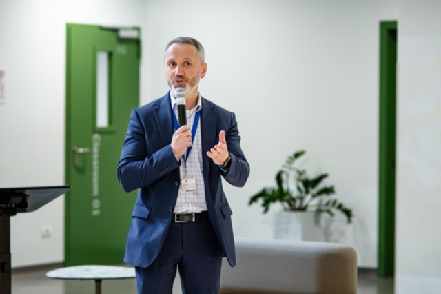 Full-length view of the keynote speaker addressing the room.