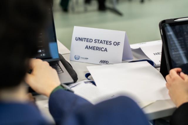 Close-up of the United States of America placard on a desk.